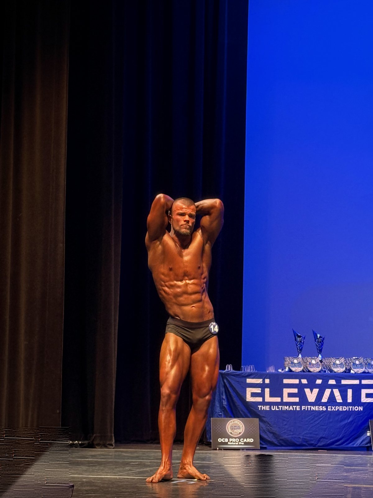 Coach Zach competing at an OCB natural bodybuilding show